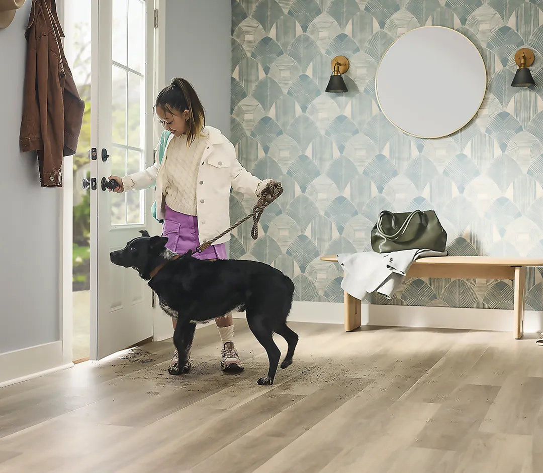 Child and dog going outside through the high traffic entryway