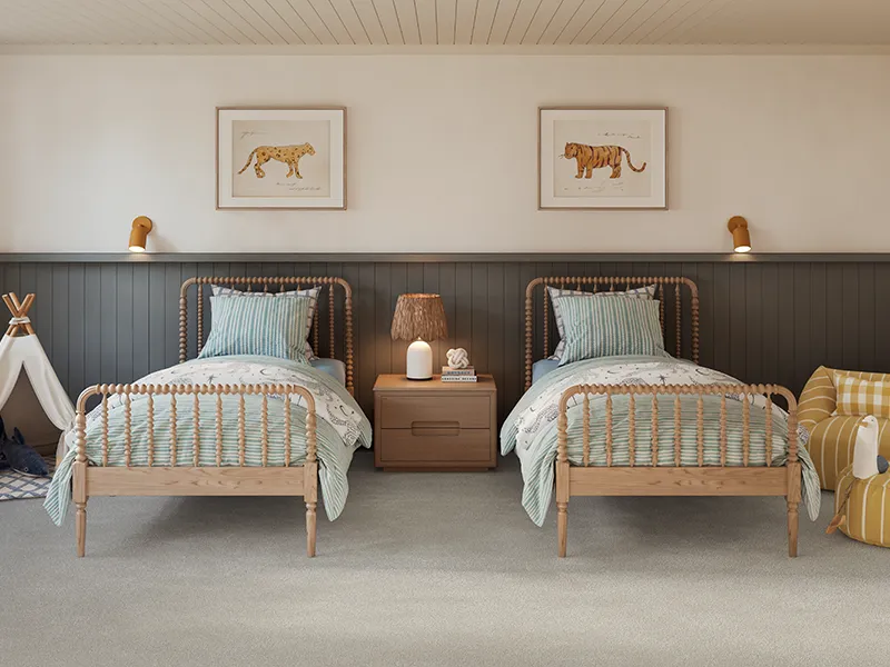 Carpet-Child-Bedroom Soft gray carpet in a children’s bedroom with twin wooden beds and animal artwork.