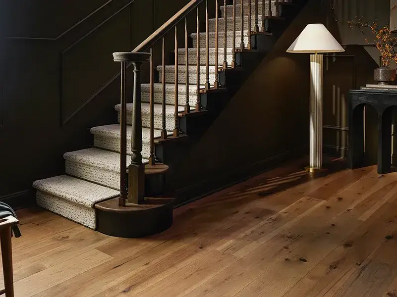 Dark wood staircase with a lightly colored custom stair runner