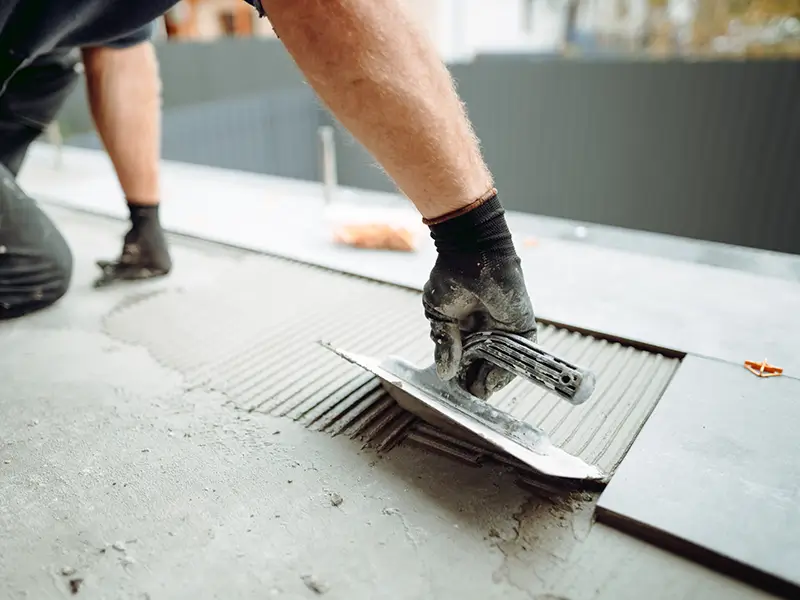 Worker installing a new tile floor