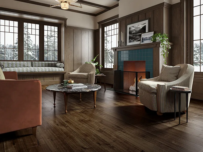New-England-Hardwood Dark hardwood flooring in a traditional living room with wood paneling and a tiled fireplace.